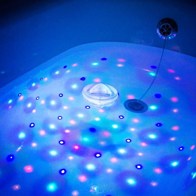 close up of the bathtub of water lit up with multi-colored disco lights