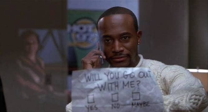 Taye Diggs in &quot;Brown Sugar&quot; holding up a sign that says, will you go out with me