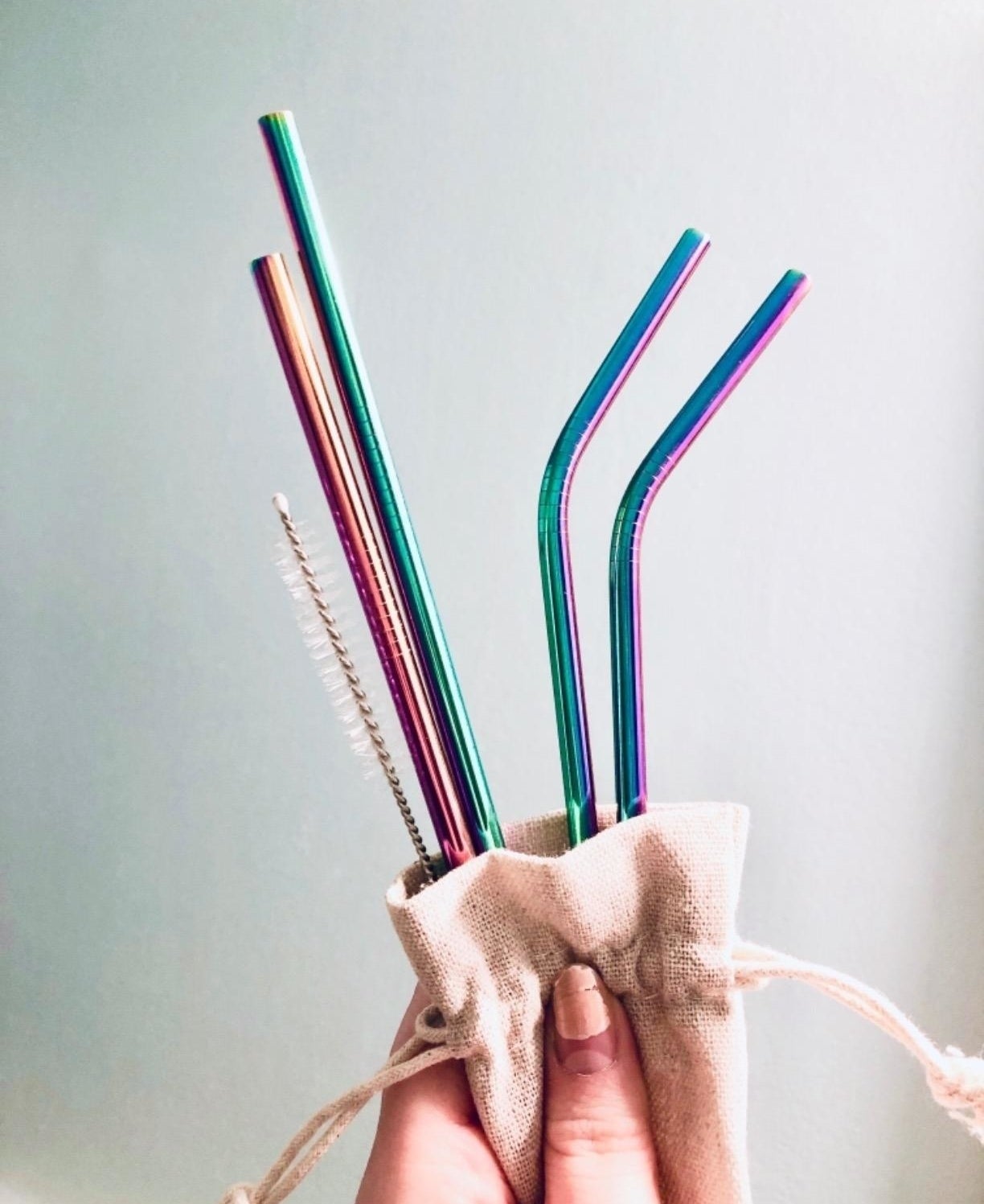 Reviewer photo showing the iridescent straws in their carrying bag