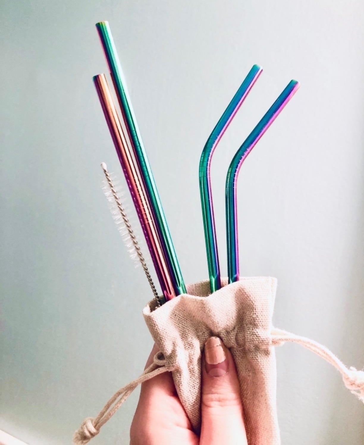 Reviewer photo showing the iridescent straws in their carrying bag
