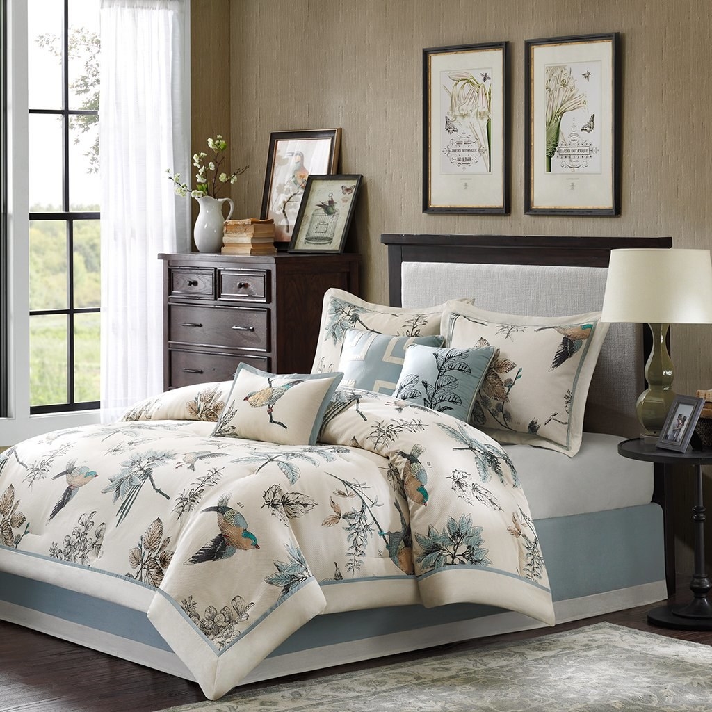 elegant bedding set with botanical print comforter, paired with decorative pillows and framed wall art in a styled bedroom