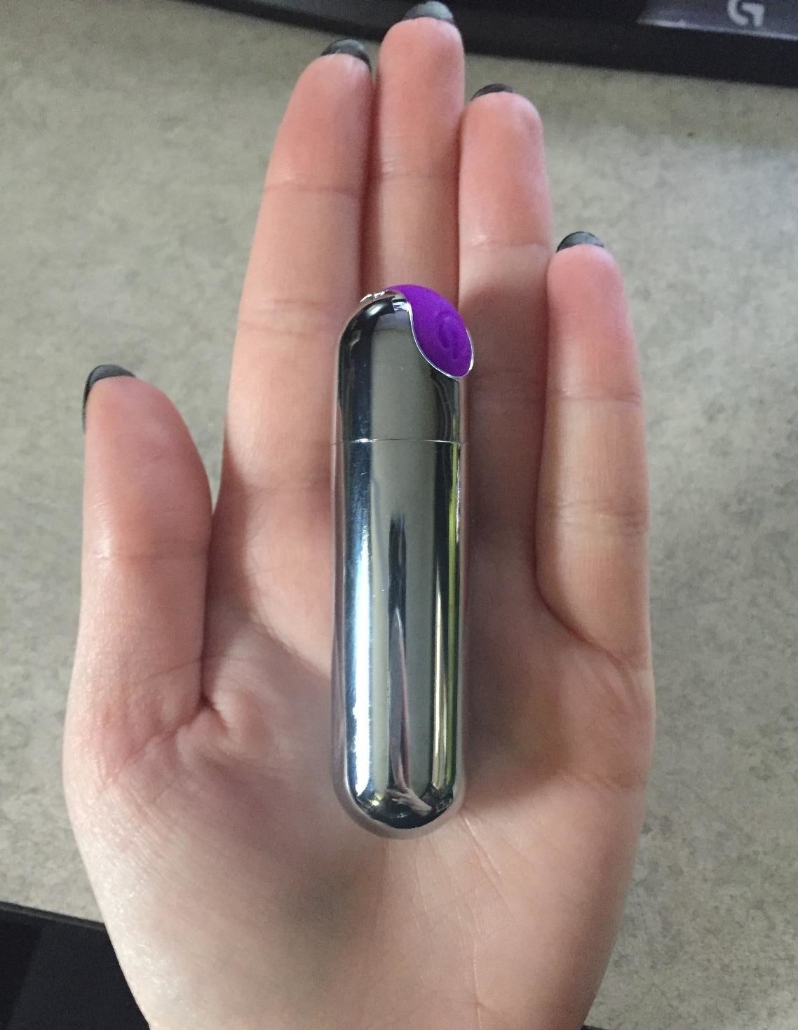 A reviewer holding the vibe. It is about the size and shape of an oval tube of lipstick.