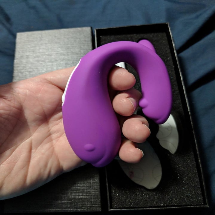 Reviewer holds flexible purple vibrator in hand