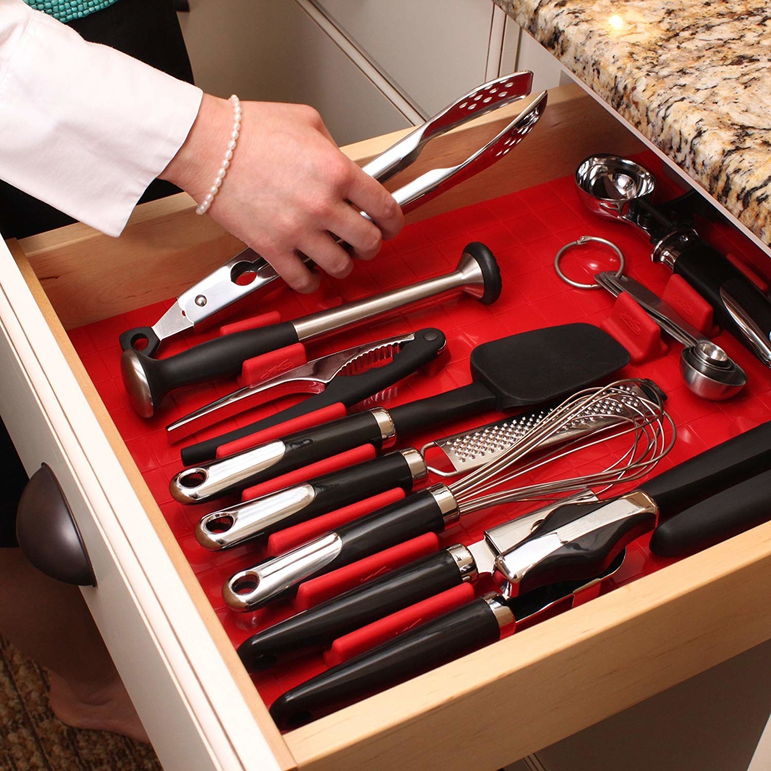open kitchen drawer with red silicone organizer with bits you can move around for a custom fit
