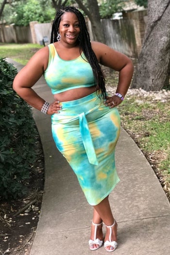reviewer in green yellow and blue tie dye tank and bodycon midi skirt set