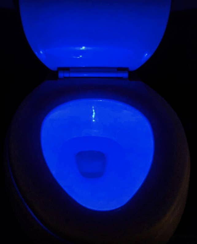 a reviewer's photo of a toilet with a blue light in it