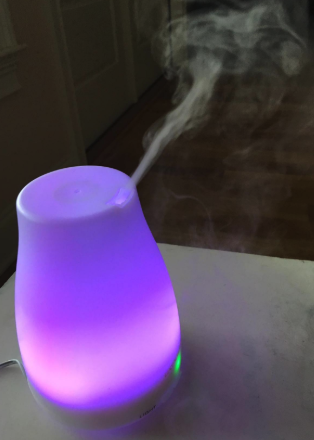 a reviewer photo of the diffuser glowing purple