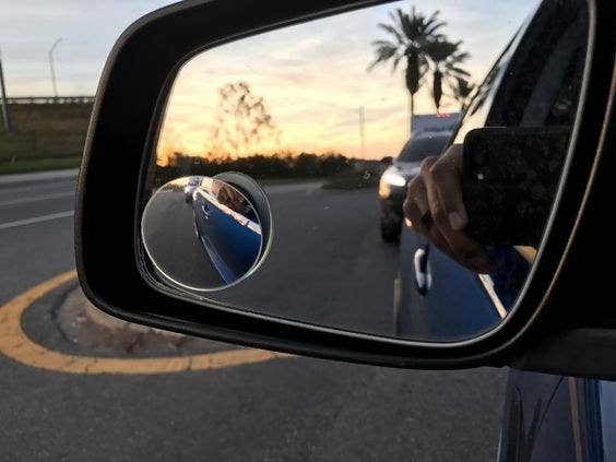 Reviewer's picture of the blind spot mirror on their side view mirror 