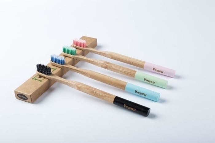 Black, blue, green, and pink bamboo toothbrushes