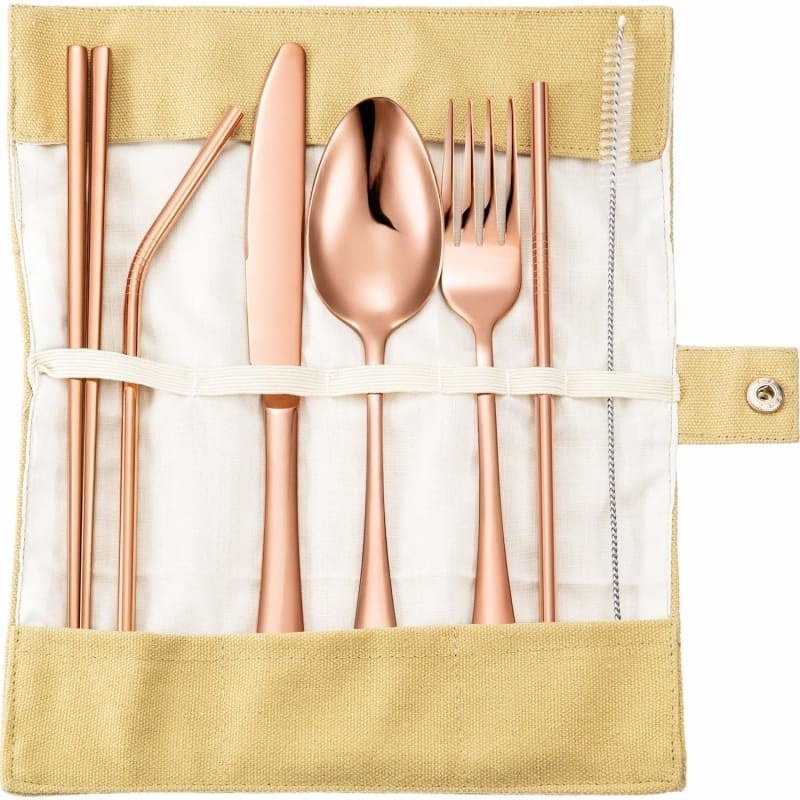 Chopsticks, bent straw, knife, spoon, fork, straight straw, and straw brush in rose gold in a beige carrying case