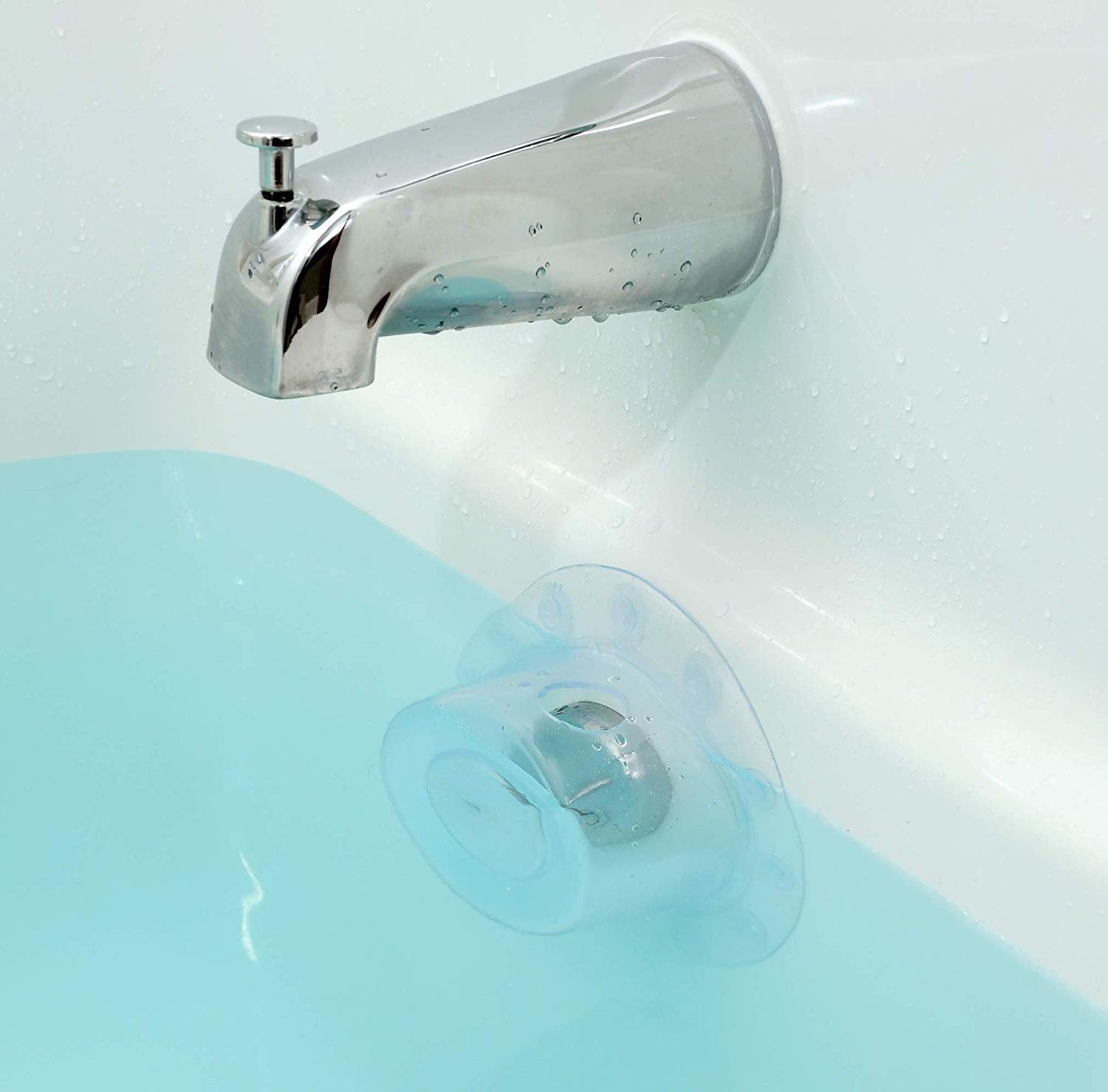 The transparent cover placed over a bathtub drain, preventing water from draining