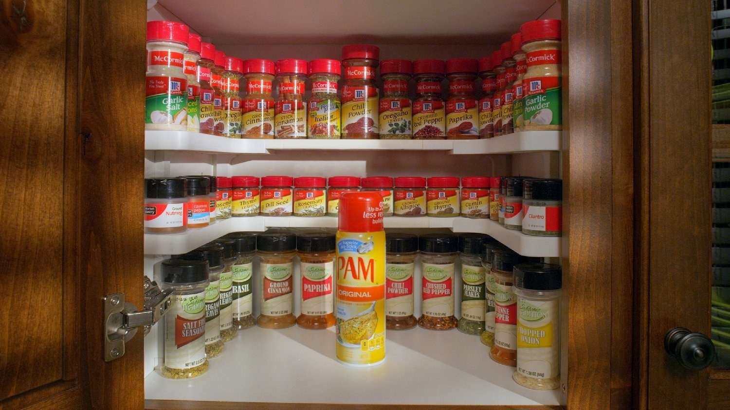 Spices lined up on Spicy Shelf in cabinet 