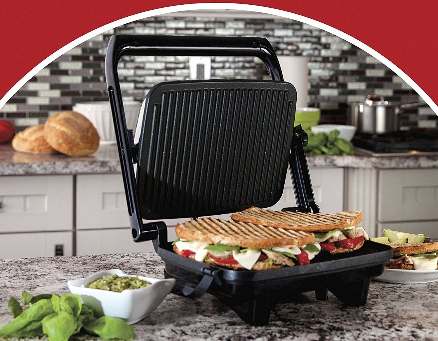 The panini press with a grilled sandwich inside