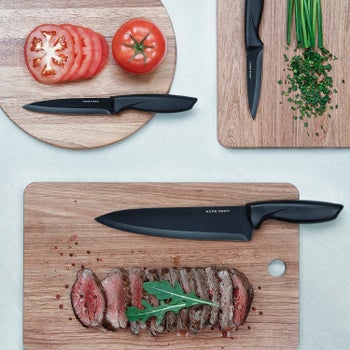 The chef's knife and paring knives on cutting boards