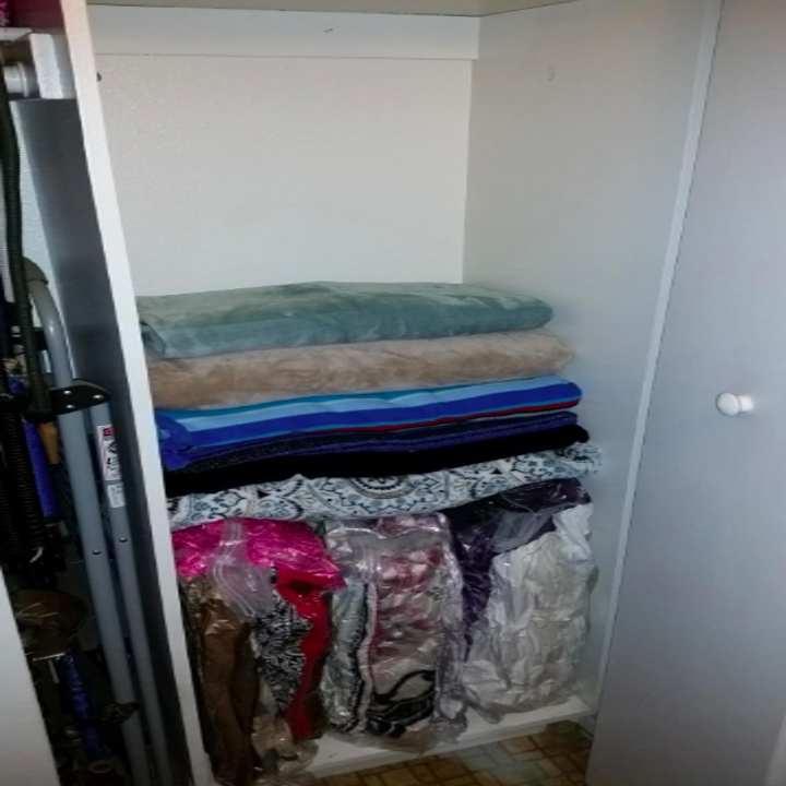 Reviewer's now clean-looking closet, with many of the blankets and towels shrunk down in the bags