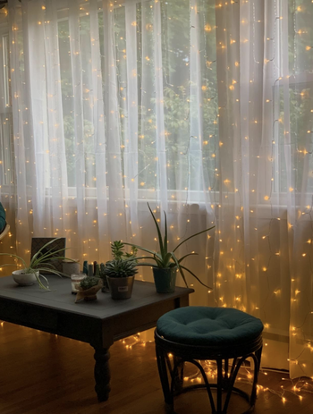 A close-up of the string lights with the sheer curtains