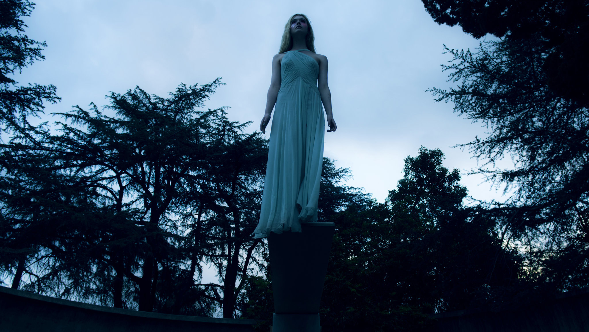 Elle Fanning&#x27;s character floats in the air in the middle of the woods