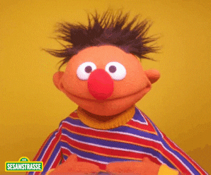 Ernie from Sesame Street smiling and giving a thumbs-up