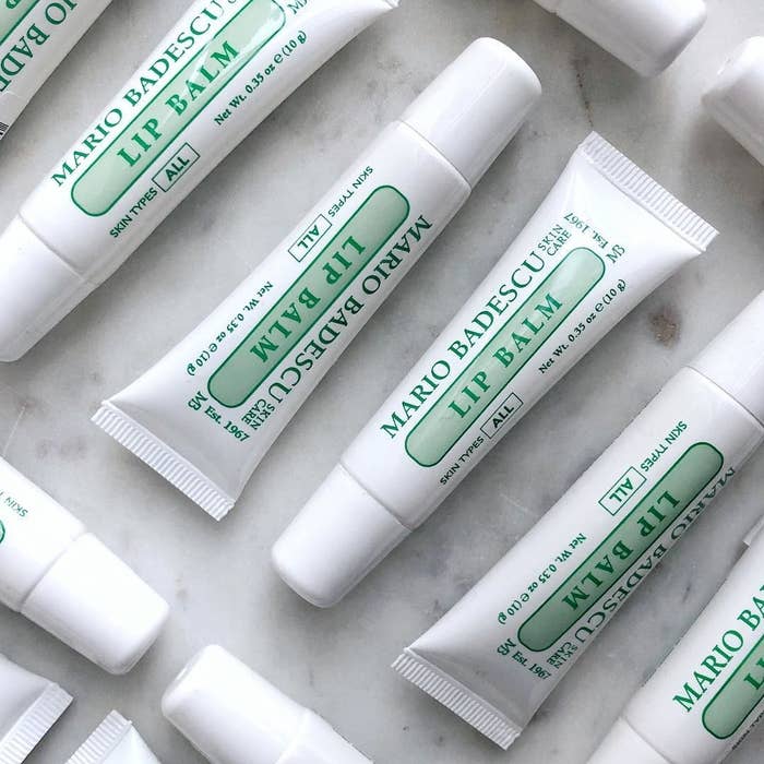 several white plastic tubes labeled &quot;Mario Badescu lip balm&quot; in green font