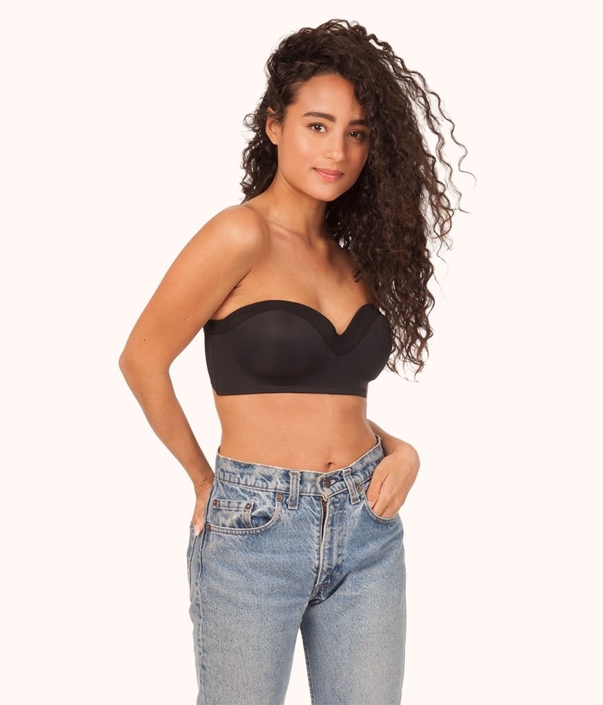 Model wearing black strapless bra