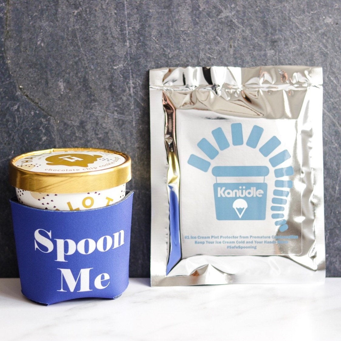 A pint of Halo Top ice cream is inside a large blue thermal jacket that says &quot;spoon me&quot;