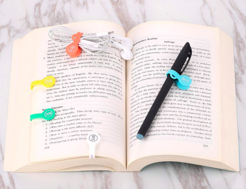 the cable clips in use as bookmarks and with headphone wires