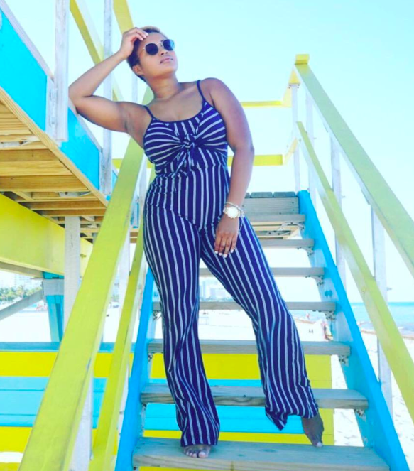 reviewer wearing navy blue and white striped tank jumpsuit 