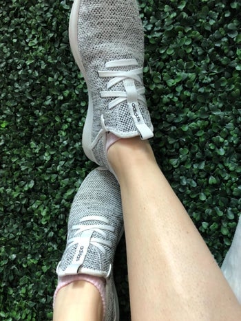reviewer wearing the sneakers in grey