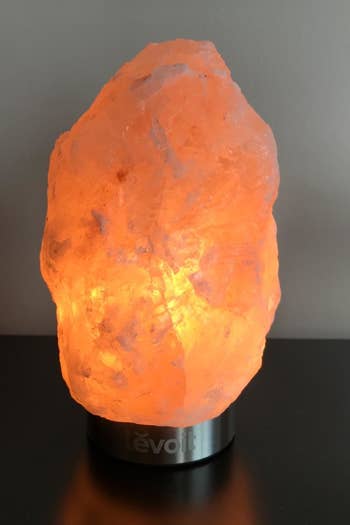 The Himalayan salt lamp emanating an amber glow