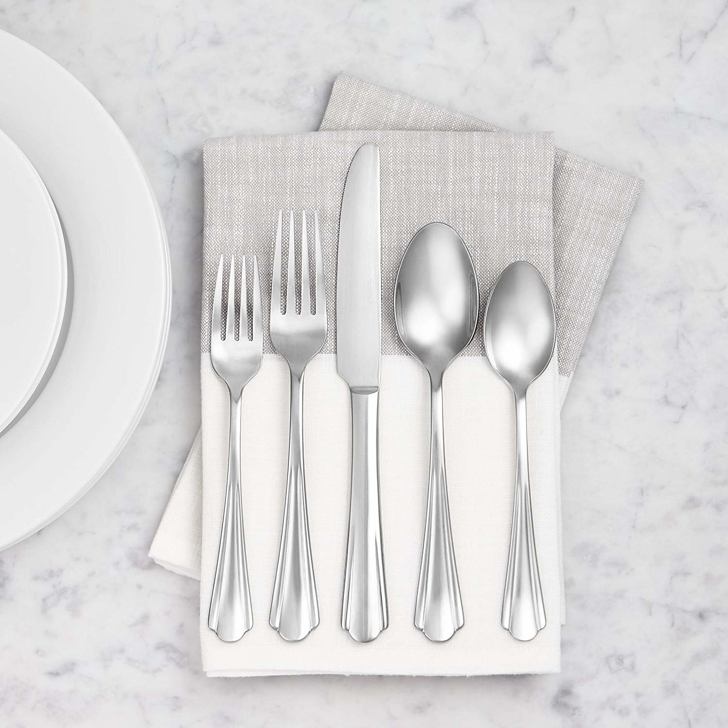 a set of silverware with scalloped edges