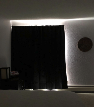 a review photo of the black out curtains blocking the sunlight