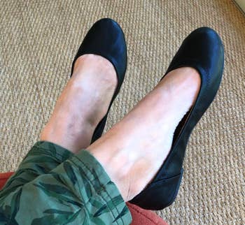 A reviewer wearing the shoes in black
