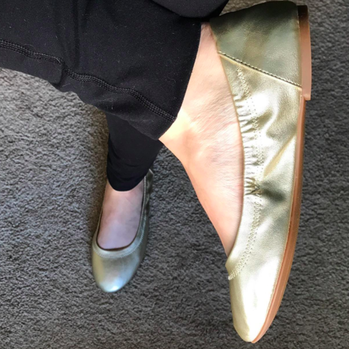 A customer review photo of them wearing the shoes in gold