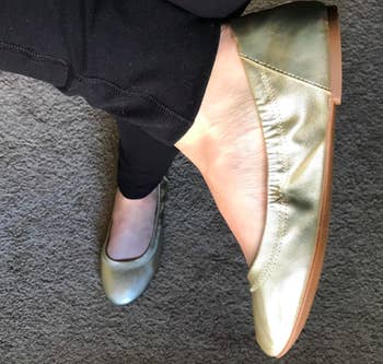 A reviewer wearing the shoes in gold