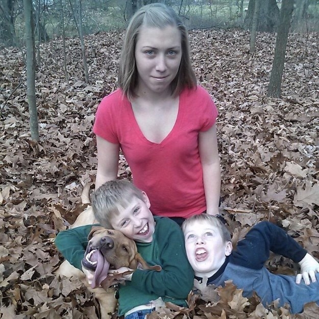 dog with the kids and human in the leaves