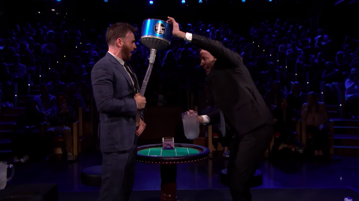 Jimmy Fallon pouring ice water into a funnel in Chris Evans&#x27; pants