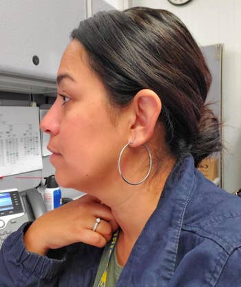 A reviewer wearing the earrings