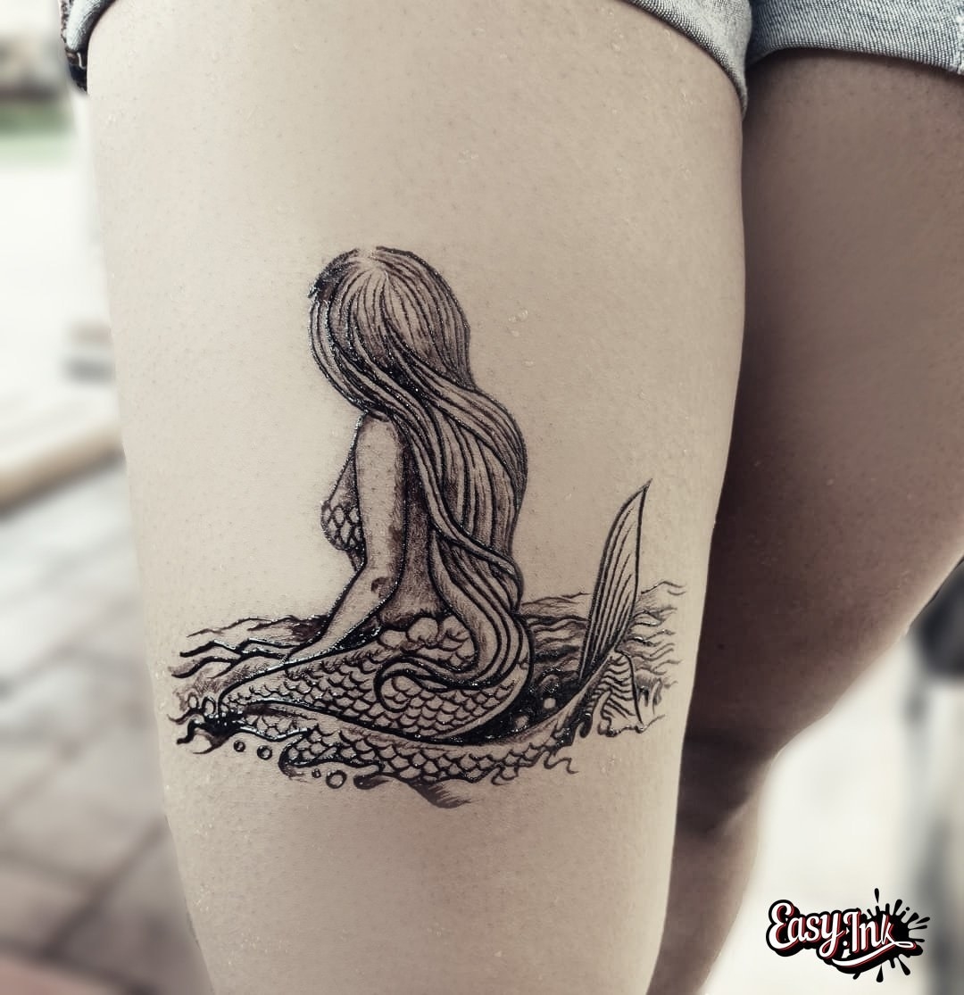 leg with mermaid tattoo
