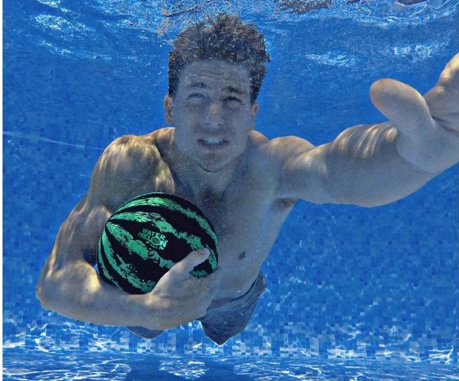 model in pool with watermelon ball