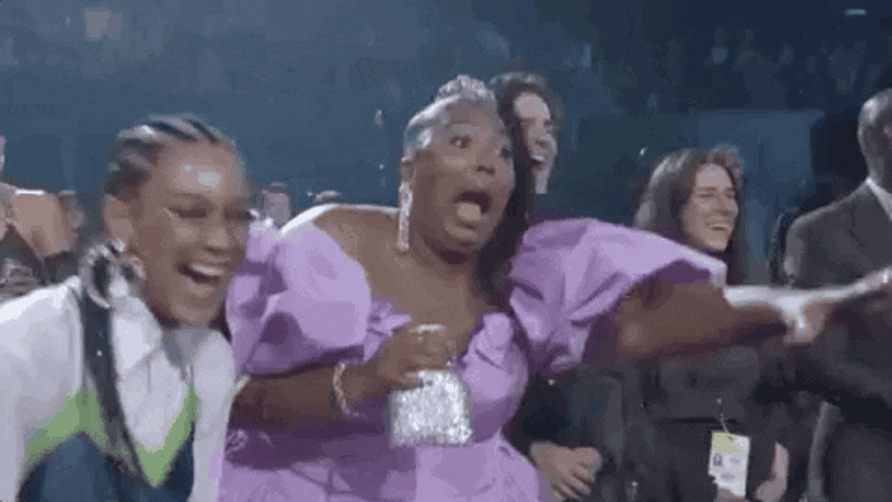 Gif of Lizzo at MTV awards show looking thrilled