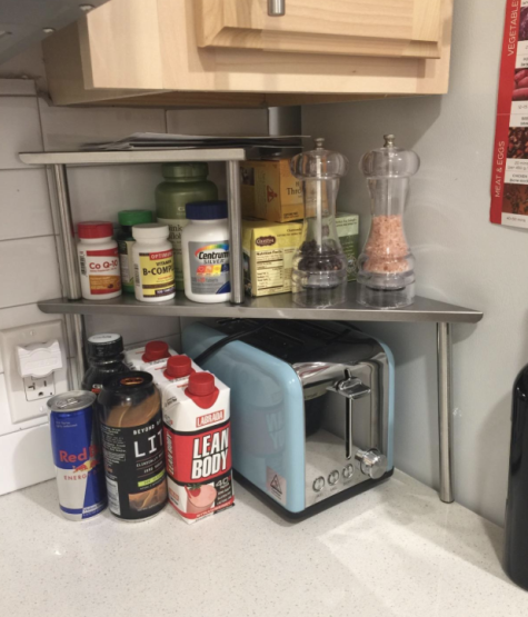 a reviewer&#x27;s photo of the shelf in their kitchen with a toaster under it 