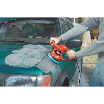 a person waxing/polishing their car