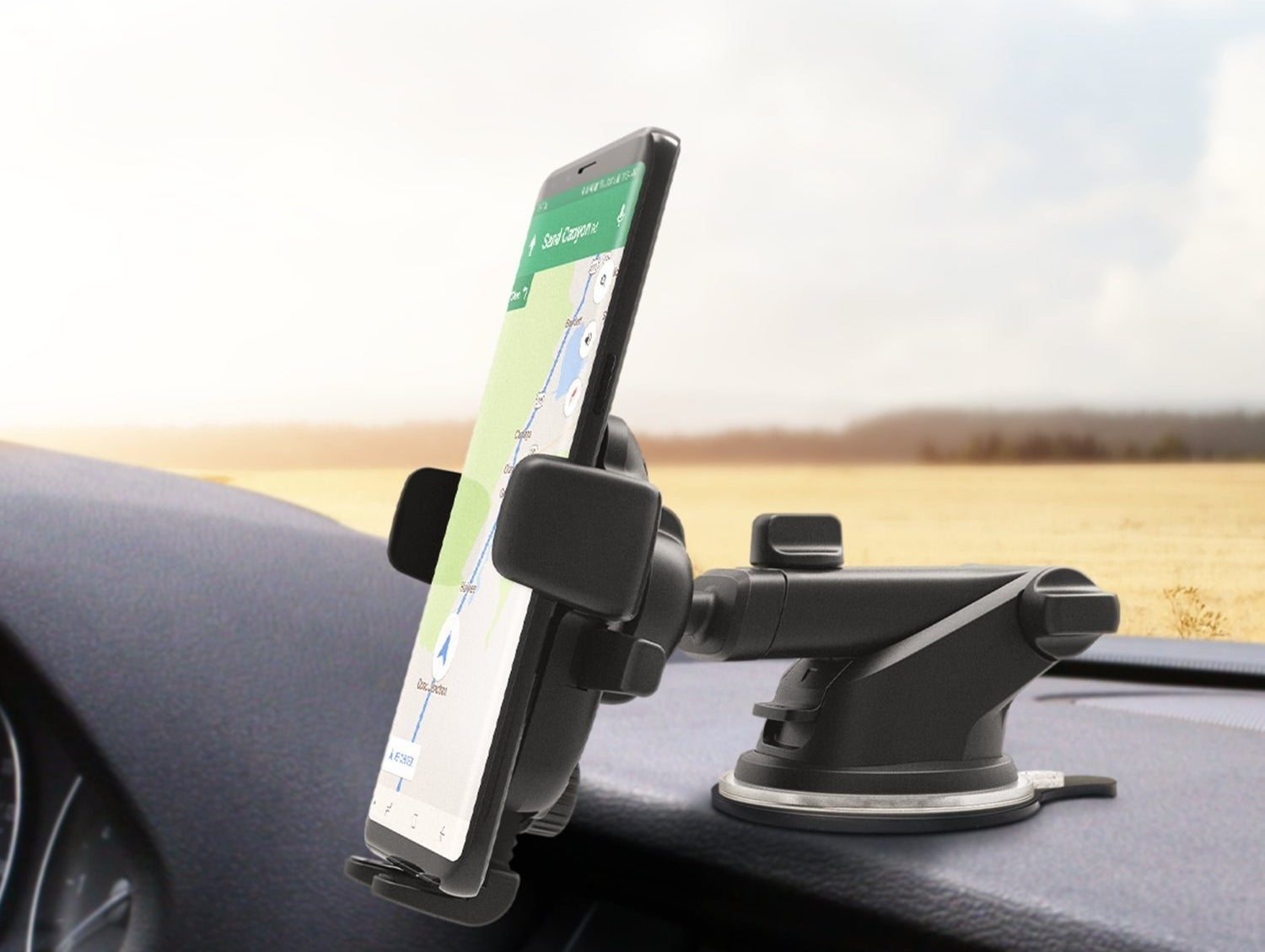 the holder mounted to a dashboard holding a smart phone