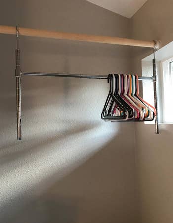 reviewer's bar with a couple of hangers below a closet pole