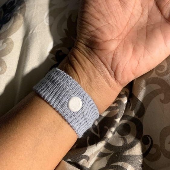 Reviewer wearing the acupressure wristband on their wrist 
