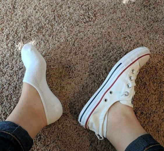 Reviewer wearing the no-show socks with Converses to show how they&#x27;re barely visible 