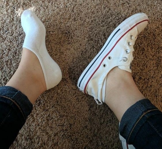 Reviewer wearing the no-show socks with Converses to show how they&#x27;re barely visible 