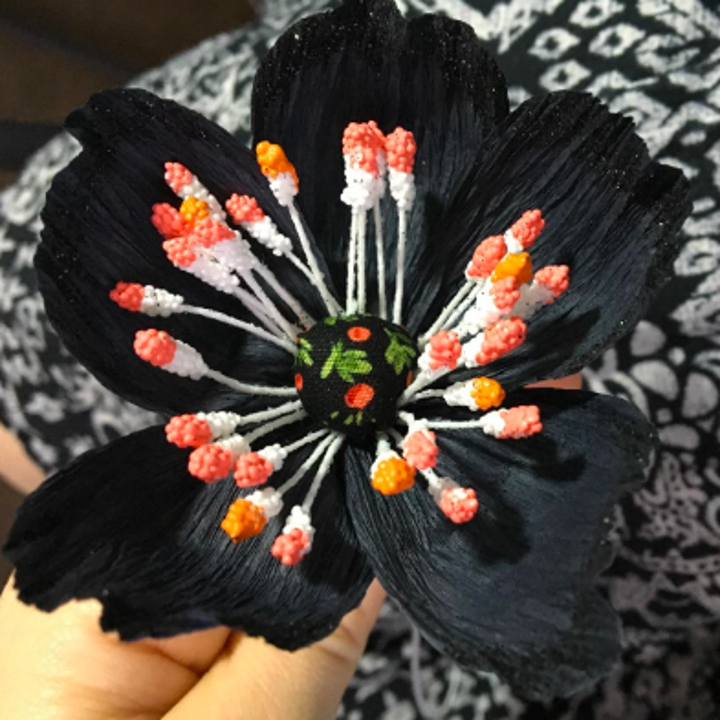 A reviewer holding a handmade flower