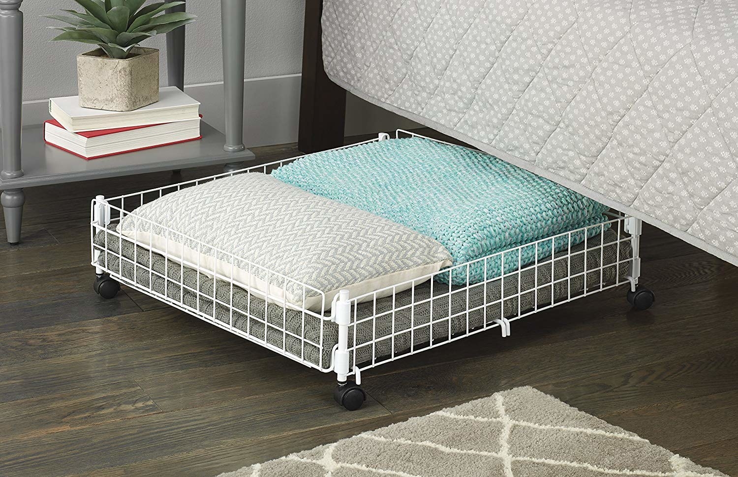 rolling basket holding blankets for storing under the bed