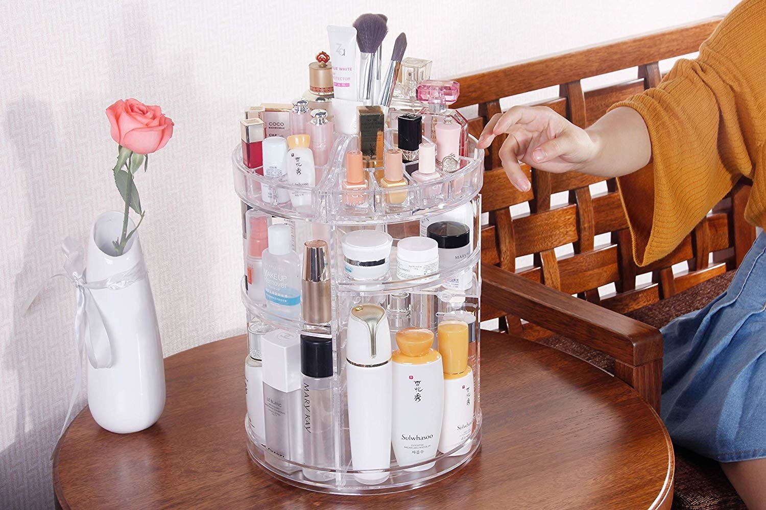 clear makeup carousel-like organizer on tabletop